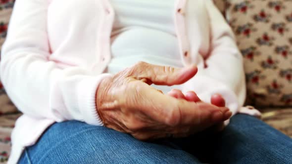 Extreme close up view of retired person rubbing her hands together