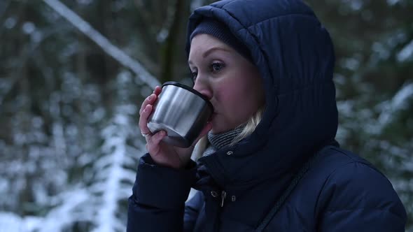 Beautiful Woman Drinking Hot Tea and Enjoys