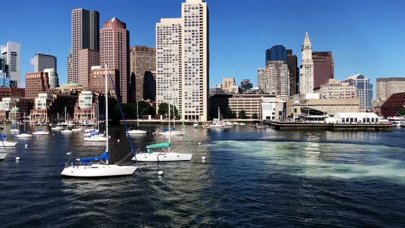 Boston skyline panning from board of a ship with view of Inner Harbor, small boats and the skyline o