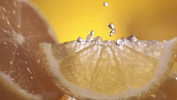 Slow Motion Shot of Lemon and Water Splashing Through Lemon Slices