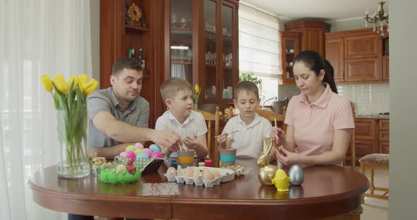 Easter Painting  Family with Two Boys Coloring Easter Eggs