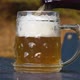 Delicious bottle of beer flows into a classic German beer glass - VideoHive Item for Sale