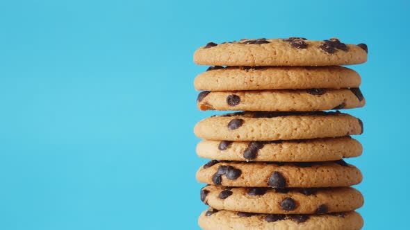 A Stack Chocolate Chip Cookies Rotate on a Blue Background