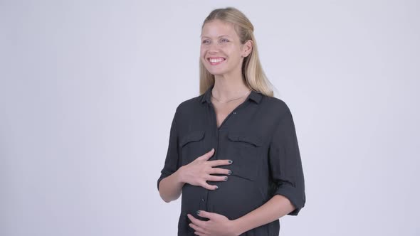 Young Happy Pregnant Businesswoman Smiling and Thinking