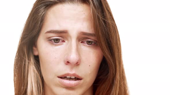 Young Beautiful Girl Crying Over White Background