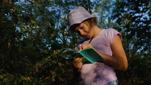 Curious Kid Naturalist Scientist Explores Plant Life Insect Life and Take Notes in Notebook