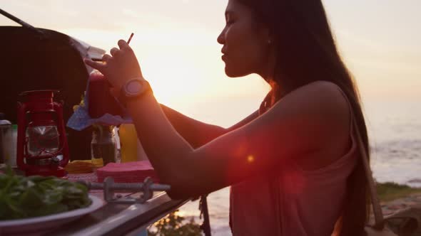 Young woman drinking a smoothie from food truck