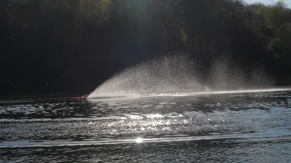 Person in Radiocontrolled Boat Turns Sailing on Lake