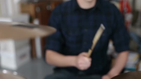 Closeup of man playing drums in garage band