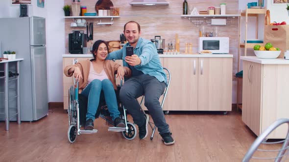 Positive Woman in Wheelchair and Husband Taking a Selfie