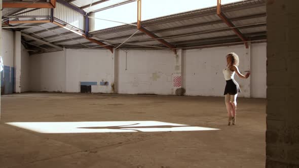 Female dancer in an empty warehouse