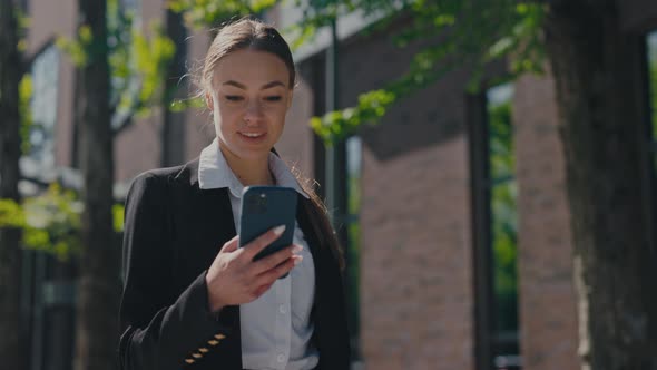 Business Lady Getting Good News on Mobile Outdoors