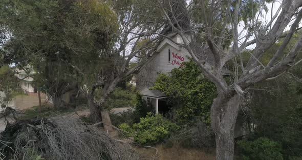 Aerial of Abandoned Overgrown Church hidden my trees Monterrey Fort Ord California