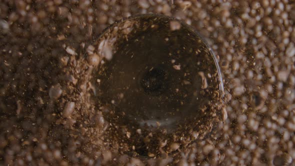 Rotating Coffee Beans Grinding in Mill Close Up