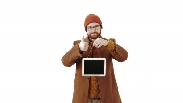 Handsome Caucasian Man Holds Small Blackboard and Shows Thumb Up Isolated Studio Shot White