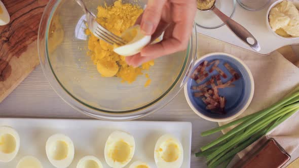 Preparing deviled eggs with organic eggs for appetizer. Step by step recipe.