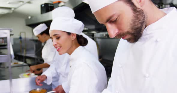 Team of chefs chopping vegetables and preparing food