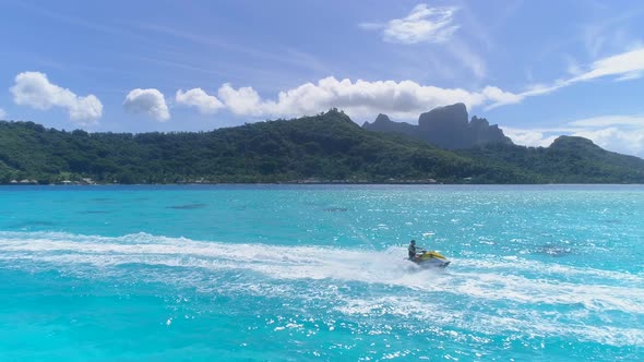 Aerial drone view of jetski personal watercraft in Bora Bora tropical island.