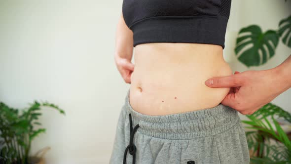 A Woman Shows a Slim Body After a Training Closeup