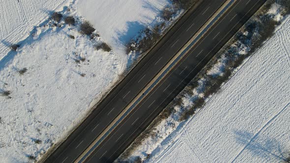 Cars driving down the snowy highway