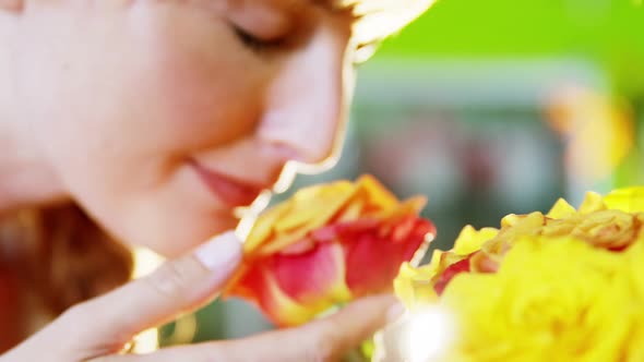 Beautiful female florist smelling rose