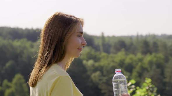 Woman Drinking Water From Bottle on Hot Sunny Summer Day