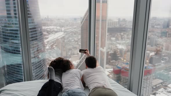 An Authentic Shot of a Happy Family Taking a Selfie or Video Call To Their Father or Relatives in