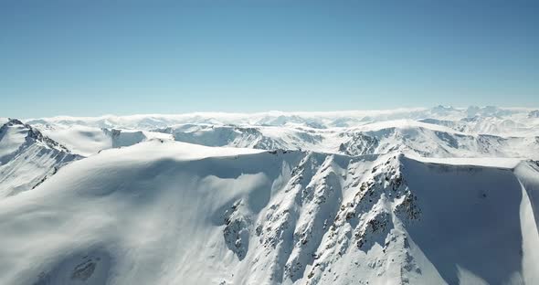 Flying Over the Tops of Snowy Mountains