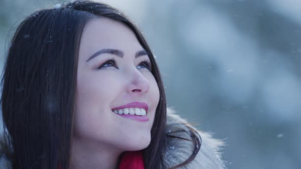 Girl watching the snow falling