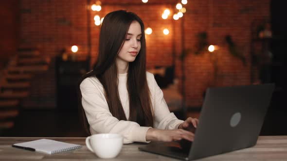 A Woman is Sitting in Her Home Office