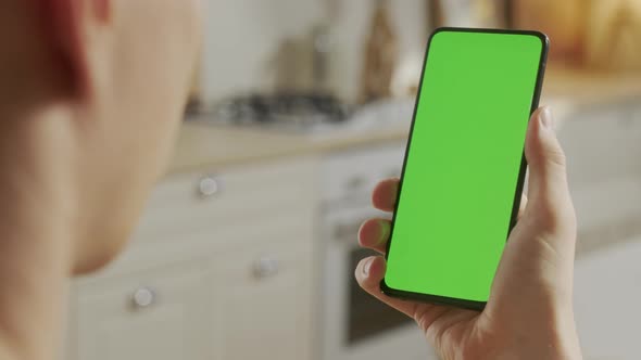 Back View of Man at Phone with Green Screen for Copy Space