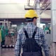 Engineer in Hard Hat is Walking Through Factory - VideoHive Item for Sale