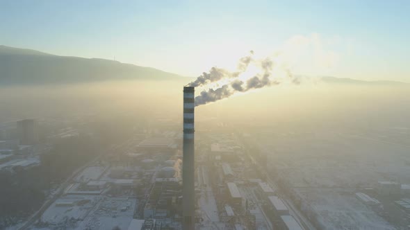 Industrial Zone with a Large Red and White Pipes. Thick White Smoke Is Pouring in the Air