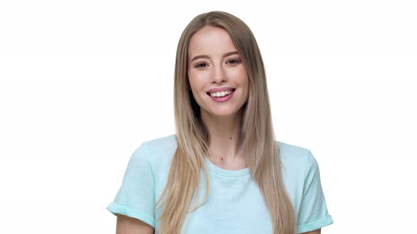 Portrait of Caucasian Woman 20s Wearing Basic Tshirt Laughing with Perfect Smile Isolated Over White