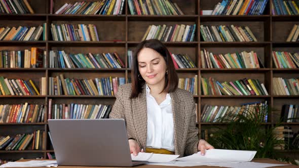 Delighted Brunette in Brown Jacket Throws Up Papers with Joy