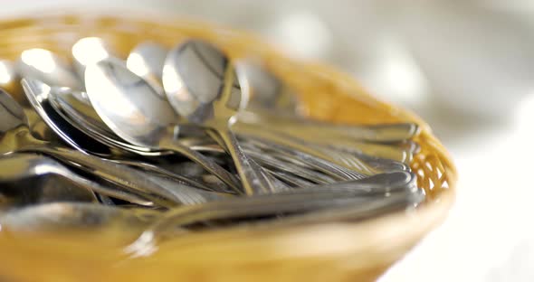 Several Spoons in Wooden Basket on Table