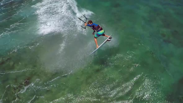 Aerial view of a man kitesurfing in Hawaii.