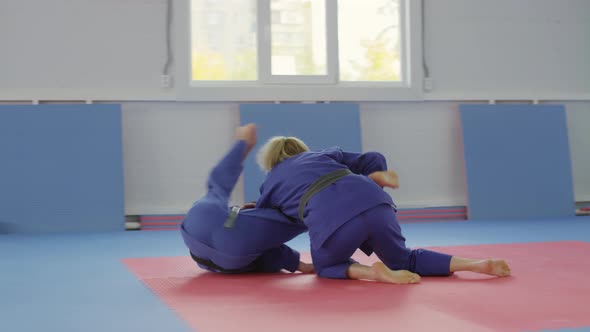 Female and Male Fighters in Kimonos Training for Jiu-Jitsu