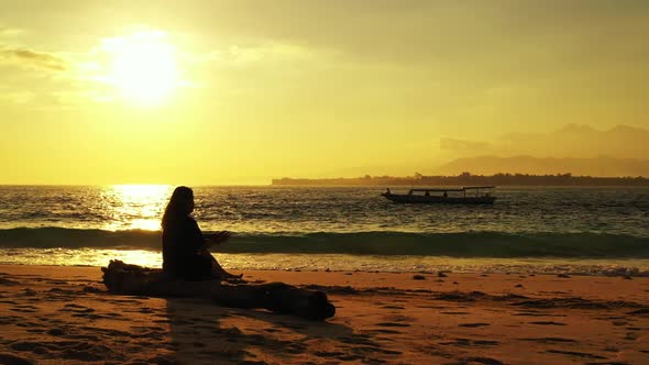 Lady alone enjoys life on relaxing shore beach journey by turquoise water and white sandy background