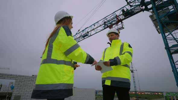 Female Civil Engineer and Foreman are Shaking Hands in Construction Site Woman Architect and Builder