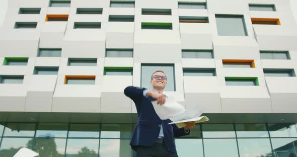 The Businessman Is Joyfully Throwing Documents Up To and Dancing