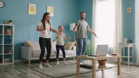 Family Is Learning Dance Using Laptop