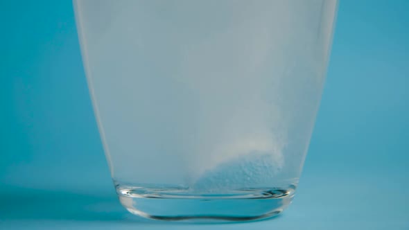 Transparent Glass Cup of Water Drops Analgin Tablet