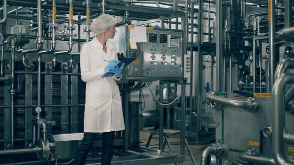 Modern Factory Unit and a Lady Employee Inspecting It