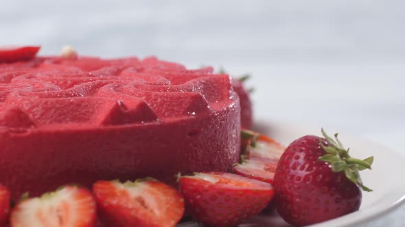 Close Up of a Pink Strawberry Cake Swirling on a White Plate