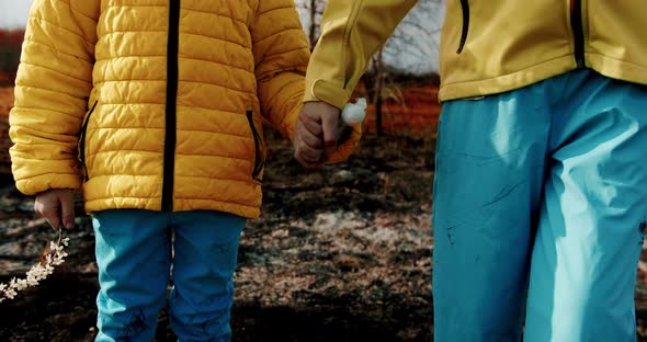 The younger sisters, dressed in the colors of the Ukrainian flag holding hands