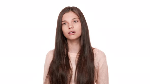 Studio Portrait of Funny Female Teen Showing Mood Swings with Facial Expressions Jump From Happiness