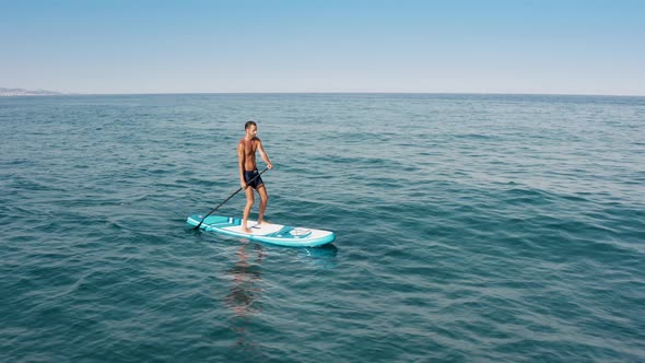 Man Navigate On Sup Board