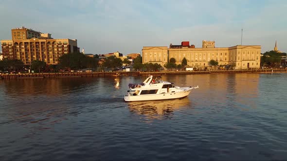 Tracking a boat on the Cape Fear River close to downtown Wilmington NC and the battleship at sunset