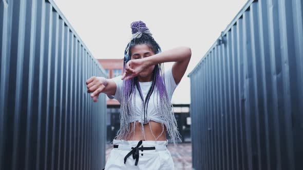 Portrait of Charismatic Energetic Young Woman with Colourful Dyed African Braids While She Listening